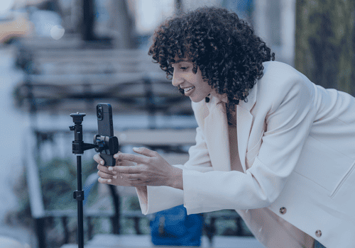 woman outside creating social content on her mobile phone